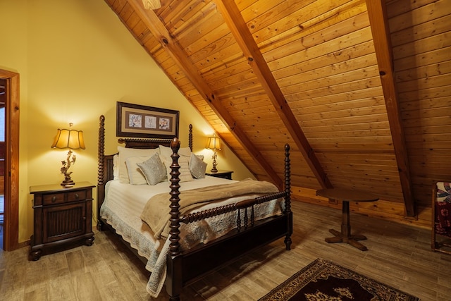 bedroom with beamed ceiling, wood-type flooring, and wooden ceiling