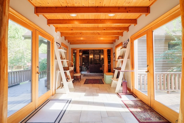 unfurnished sunroom with beam ceiling and wood ceiling