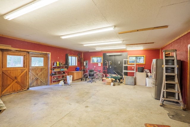 garage featuring stainless steel refrigerator