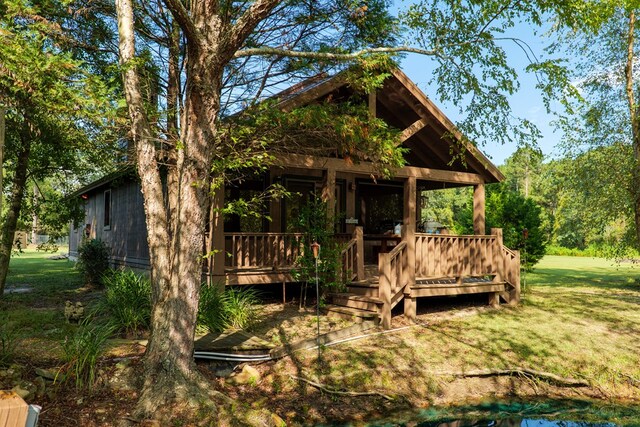 exterior space featuring a lawn and a porch