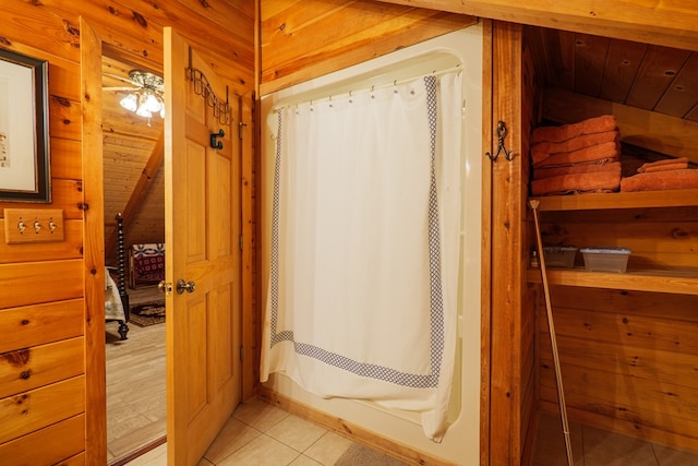 bathroom featuring tile patterned floors, wood walls, ceiling fan, and wooden ceiling