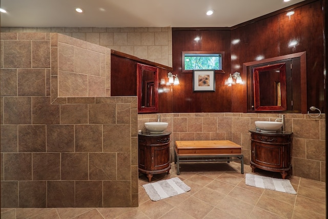 bathroom with tile patterned flooring, vanity, and tile walls