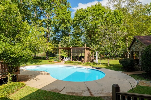 view of swimming pool with a yard and a patio