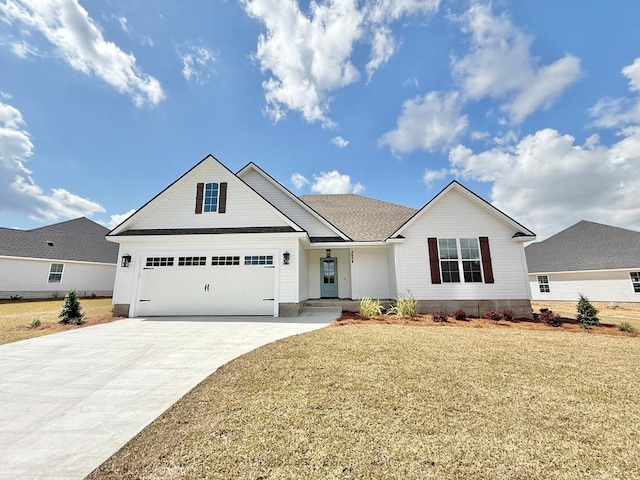 view of front of home with driveway, a shingled roof, and a front lawn