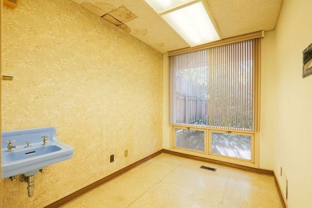 1614 N Patterson St, Valdosta, GA 31602 - empty room featuring tile patterned floors, a sink, baseboards, and visible vents