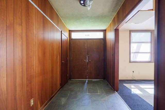 1614 N Patterson St, Valdosta, GA 31602 - entryway featuring wood walls, a healthy amount of sunlight, and stone finish floor