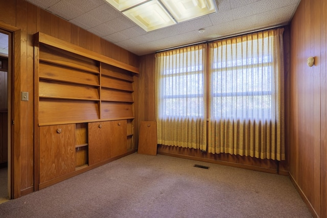 1614 N Patterson St, Valdosta, GA 31602 - empty room featuring wooden walls, visible vents, and carpet