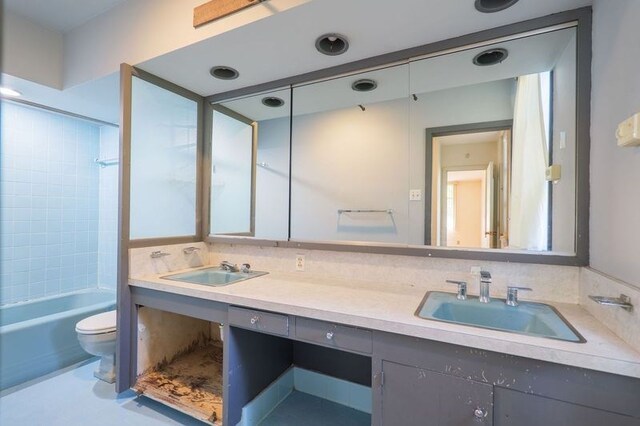 1614 N Patterson St, Valdosta, GA 31602 - full bath featuring toilet, shower / tub combination, double vanity, and a sink