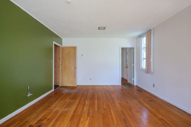 1614 N Patterson St, Valdosta, GA 31602 - empty room with baseboards, visible vents, and hardwood / wood-style flooring