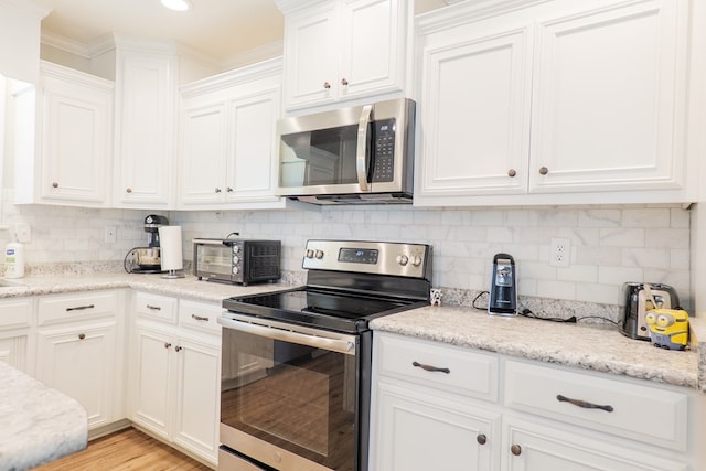 4137 Nelson Hill Pl, Hahira, GA 31632 - kitchen featuring appliances with stainless steel finishes, white cabinets, backsplash, light stone countertops, and recessed lighting