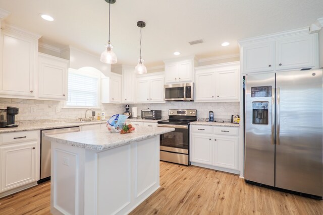 4137 Nelson Hill Pl, Hahira, GA 31632 - kitchen featuring stainless steel appliances, white cabinets, decorative backsplash, crown molding, and recessed lighting