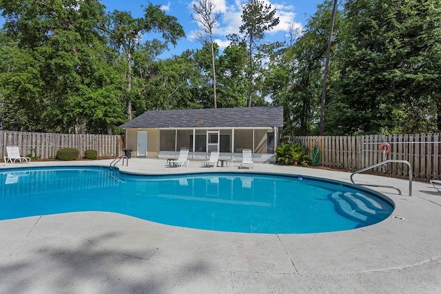 pool with an outdoor structure, a storage structure, a patio, and fence
