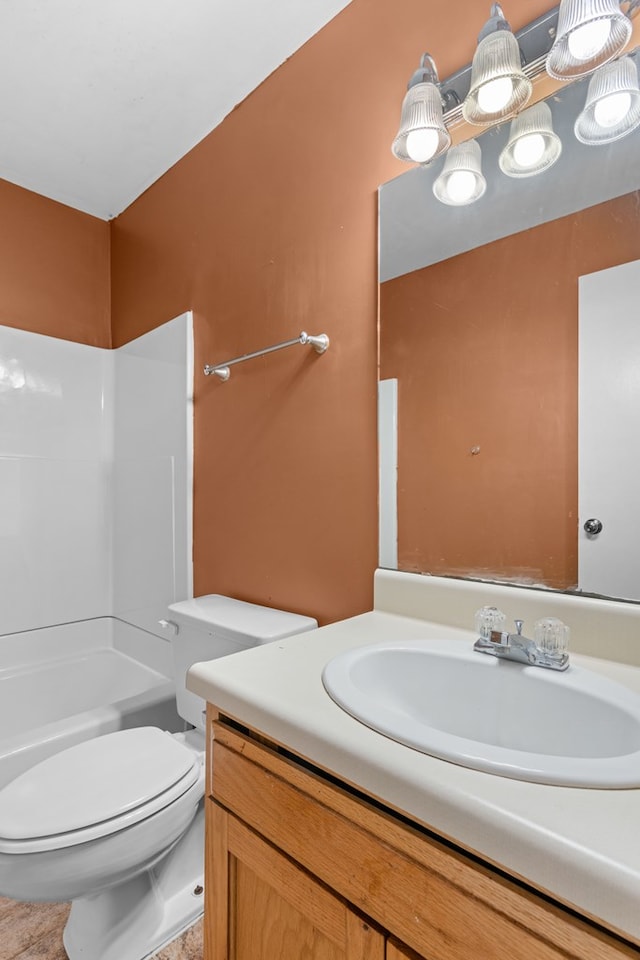 bathroom featuring toilet, vanity, and washtub / shower combination