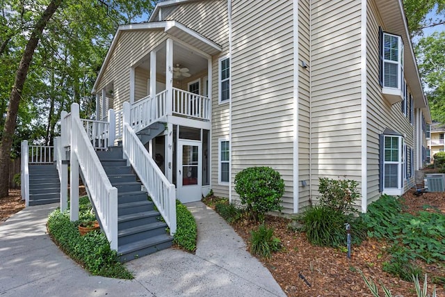 view of home's exterior with central air condition unit, stairs, and ceiling fan