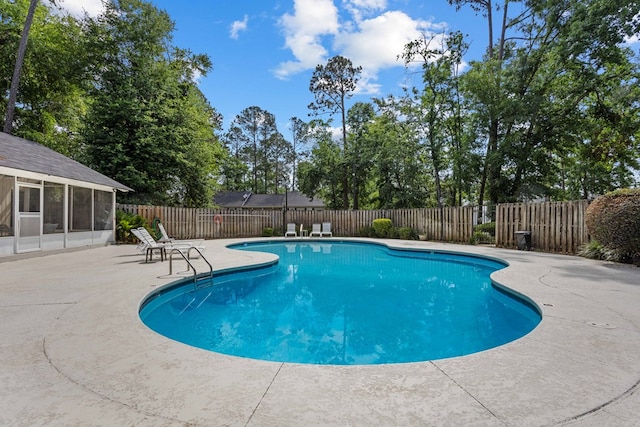 view of swimming pool with a patio area, a fenced in pool, and a fenced backyard