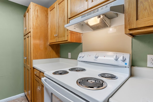 kitchen featuring light countertops, light tile patterned flooring, white electric stove, and under cabinet range hood