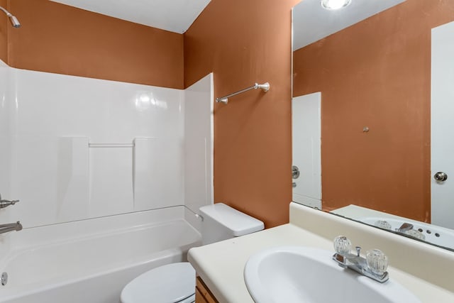 bathroom with washtub / shower combination, toilet, and vanity