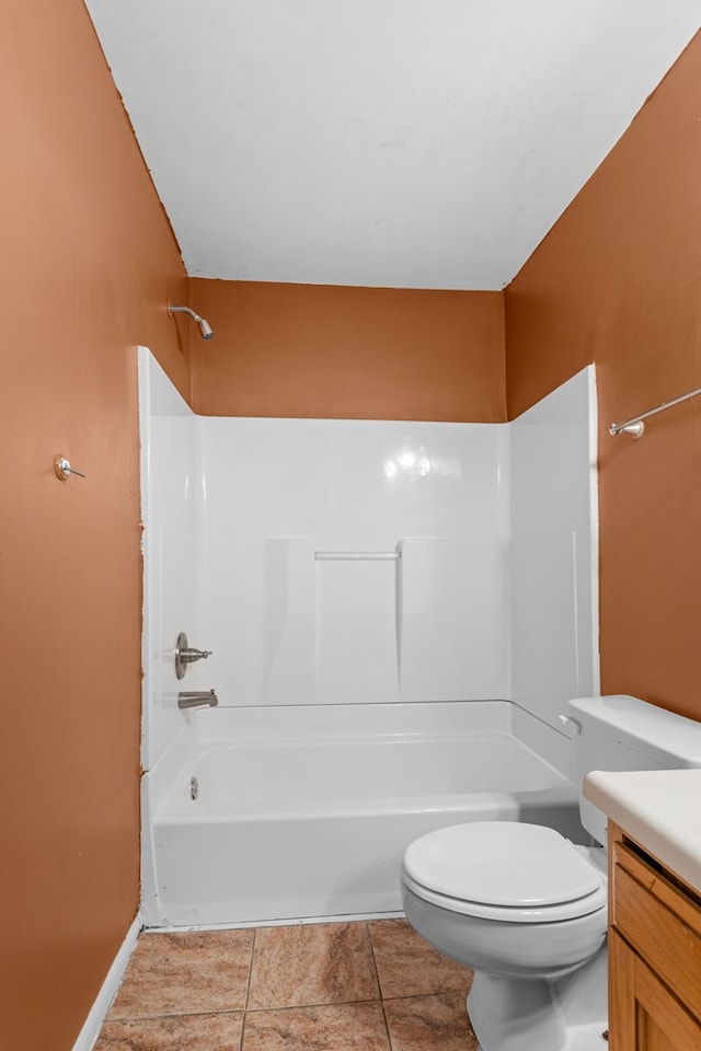 full bath featuring baseboards, toilet, vanity, and bathing tub / shower combination