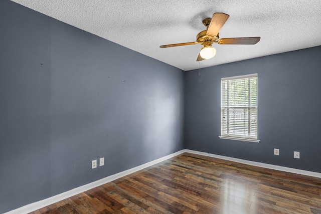 empty room with wood finished floors, baseboards, a textured ceiling, and a ceiling fan