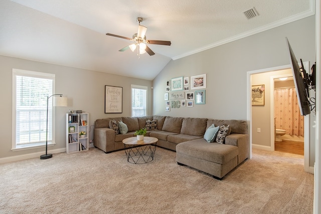 carpeted living room with a textured ceiling, ceiling fan, vaulted ceiling, and ornamental molding