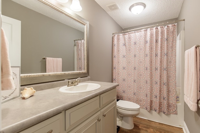 full bathroom with a textured ceiling, toilet, vanity, shower / tub combo, and hardwood / wood-style flooring