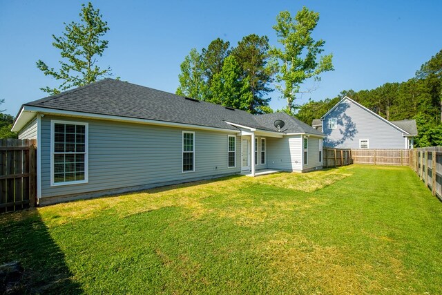 back of house with a yard