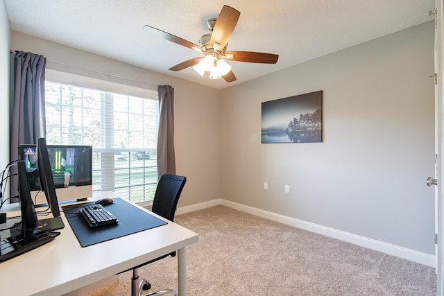 office area featuring light carpet, a textured ceiling, and ceiling fan