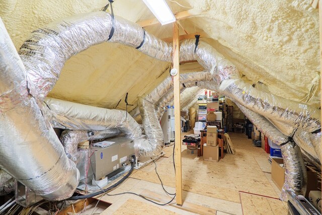 unfinished attic with electric water heater