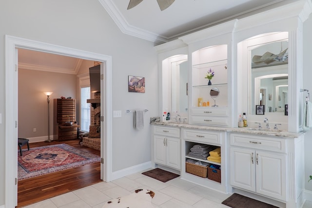 bathroom with vanity, hardwood / wood-style flooring, ceiling fan, and ornamental molding