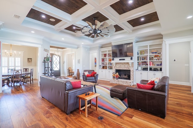 living room with wood-type flooring, a brick fireplace, coffered ceiling, and crown molding