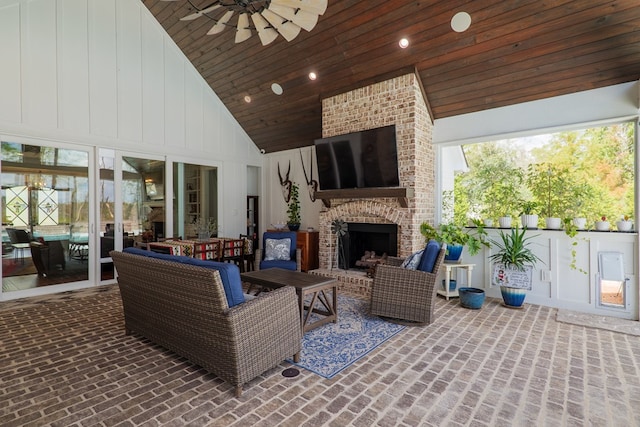 view of patio featuring an outdoor brick fireplace and ceiling fan