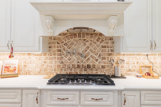 kitchen with white cabinetry, stainless steel gas cooktop, and tasteful backsplash