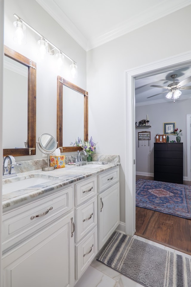 bathroom with hardwood / wood-style floors, vanity, ceiling fan, and ornamental molding