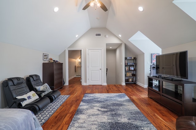 living room featuring ceiling fan, dark wood-type flooring, and vaulted ceiling