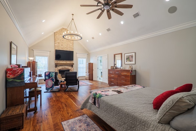 bedroom with hardwood / wood-style floors, a large fireplace, ornamental molding, and high vaulted ceiling