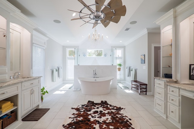 bathroom featuring a washtub, tile patterned flooring, crown molding, a chandelier, and vanity