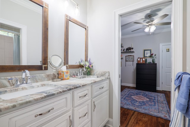 bathroom with hardwood / wood-style floors, vanity, ceiling fan, and ornamental molding