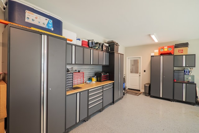 kitchen with gray cabinets and stainless steel refrigerator