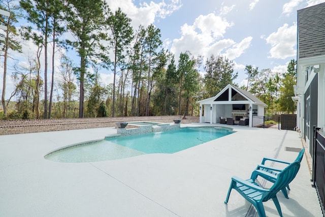 view of pool with a patio area, an outbuilding, and an in ground hot tub