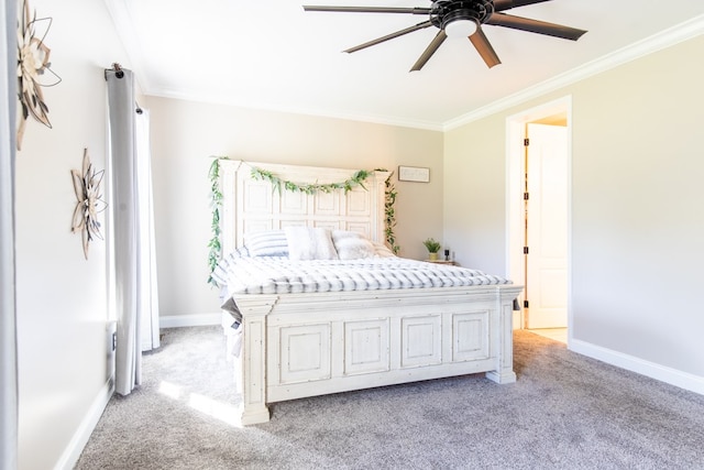 carpeted bedroom featuring ceiling fan and crown molding