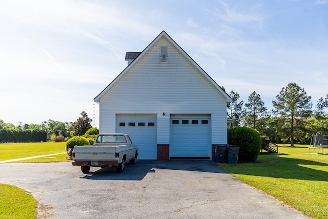 view of home's exterior with a lawn and a garage