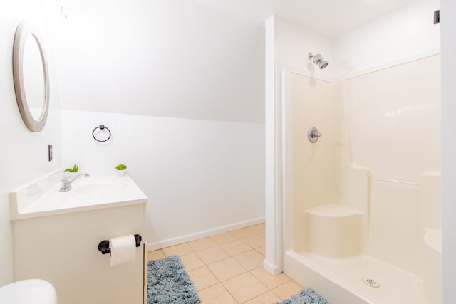 bathroom featuring tile patterned floors, vanity, and walk in shower