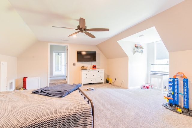 carpeted bedroom with ceiling fan and vaulted ceiling