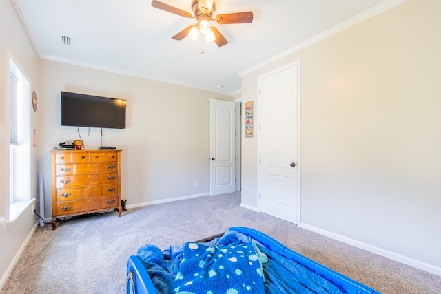 bedroom with carpet flooring, ceiling fan, and crown molding