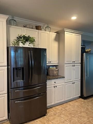 kitchen featuring stainless steel fridge, black refrigerator with ice dispenser, and ornamental molding