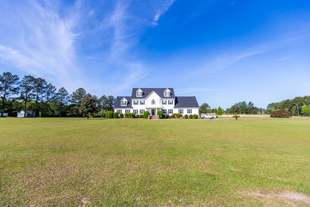 cape cod-style house with a front yard