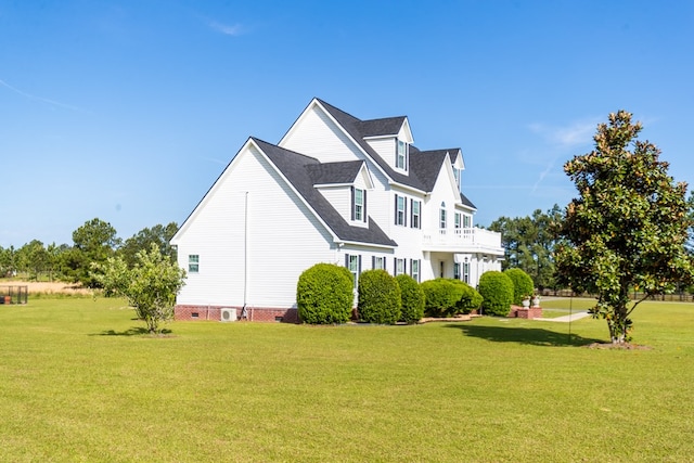 view of property exterior featuring a yard and a balcony