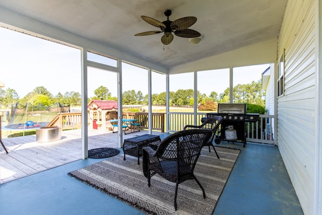 sunroom with ceiling fan, a healthy amount of sunlight, and vaulted ceiling