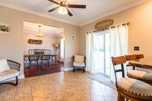 interior space with ceiling fan, crown molding, and light tile patterned floors