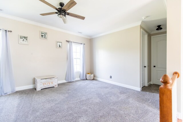 spare room featuring carpet floors, ceiling fan, and ornamental molding